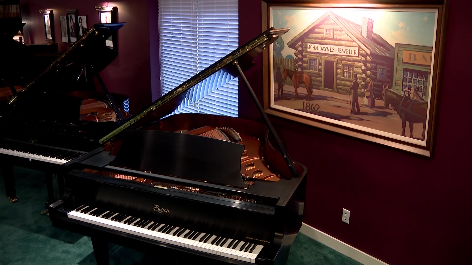 A piano with a portrait of John Daynes’ 1862 cabin.