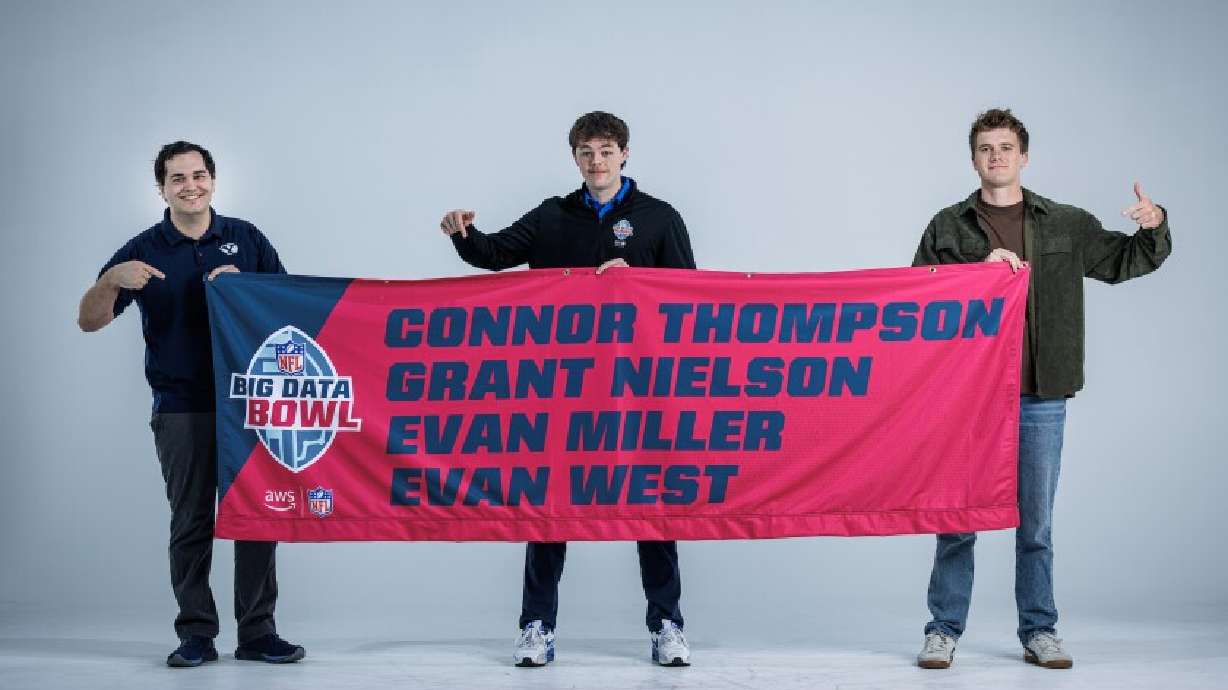 Connor Thompson, Grant Nielson and Evan Miller with a banner featuring their names at the NFL Big Data Bowl during the NFL combine. A team of BYU graduate students and a UVU graduate was one of five winners of the event.
