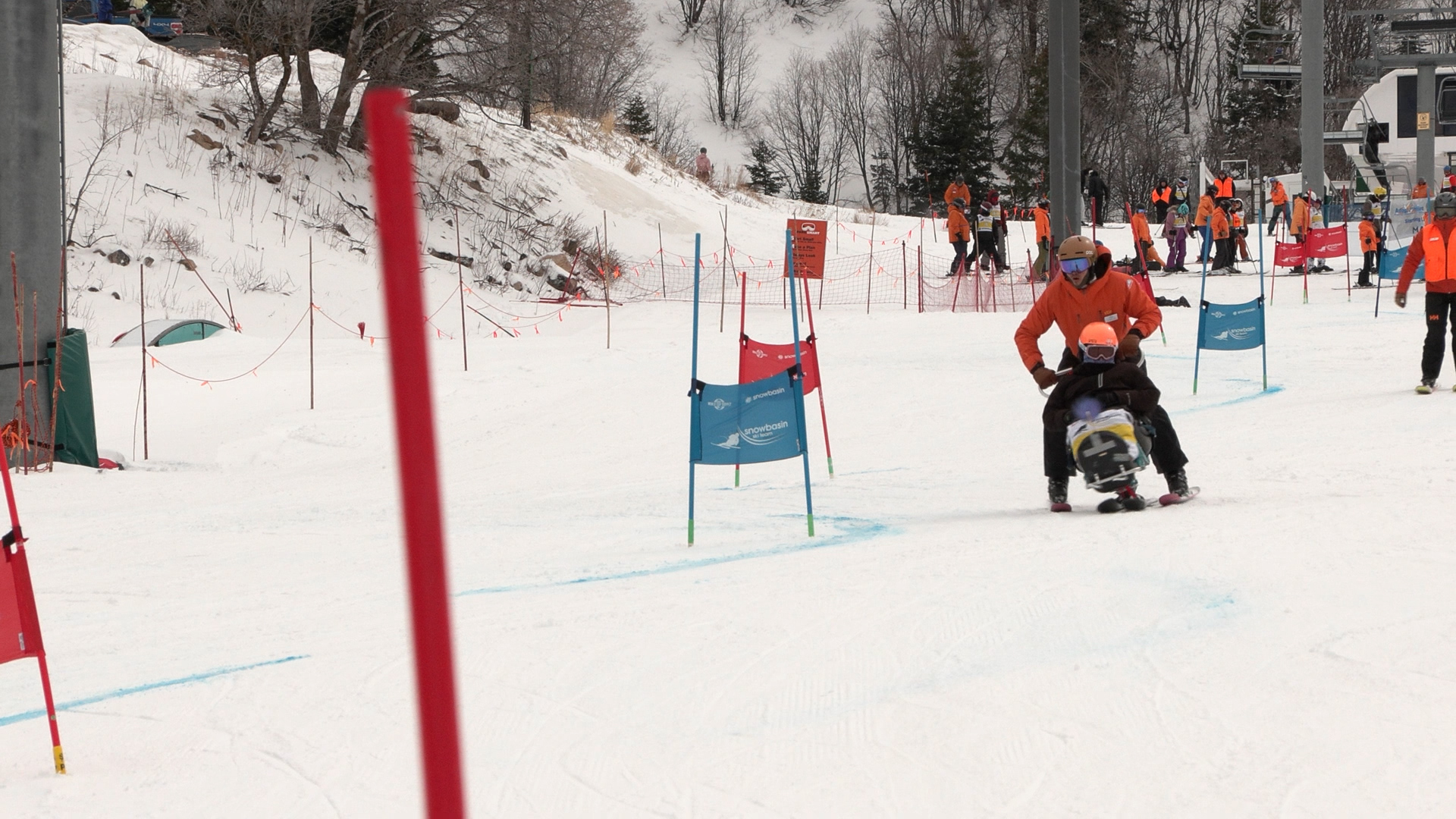 An instructor with Ogden Valley Adaptive guides a client on a sit-ski, Friday. Executive Director Brandon Flint said the organization works to help people with disabilities get out and get active year-round.