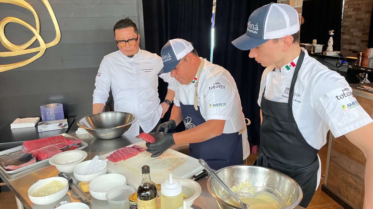 Chef Oliver Seki of Ensenada, Mexico, center, prepares tuna tartar at Monarca in Salt Lake City on Thursday as Alfonso Brito, the Monarca chef, left, and Alejandro Blanco-Rosas look on.