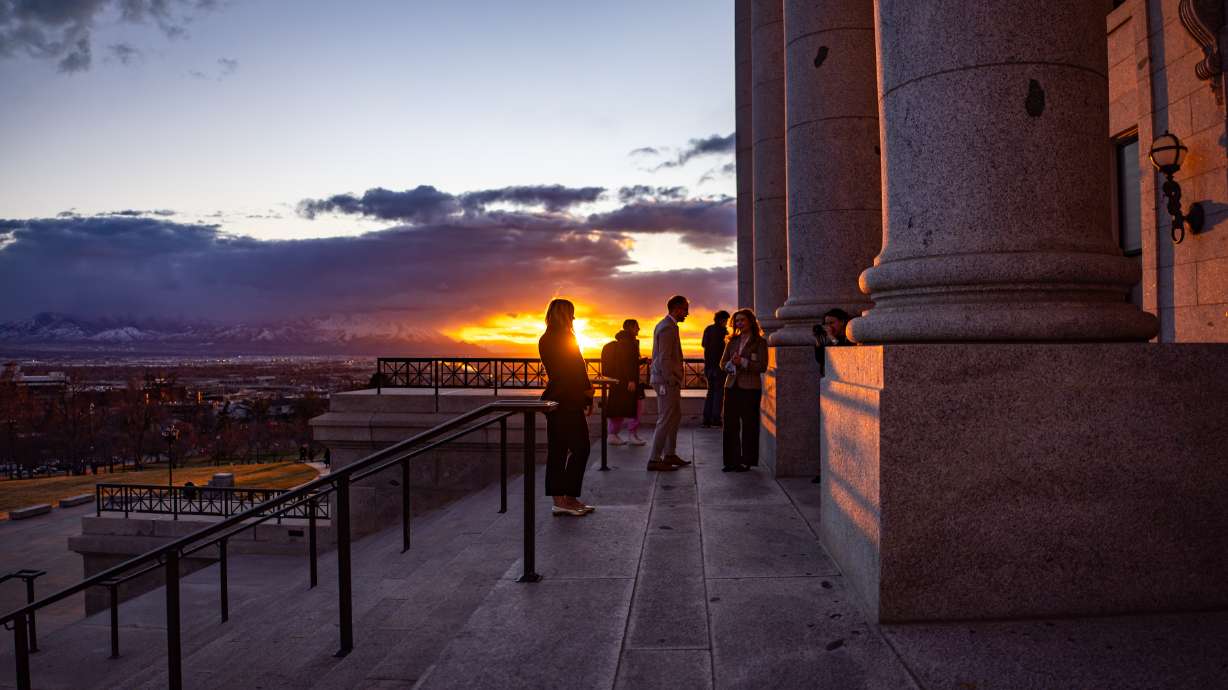 People stand outside during the last day of the legislative session at the Capitol in Salt Lake City on Friday.