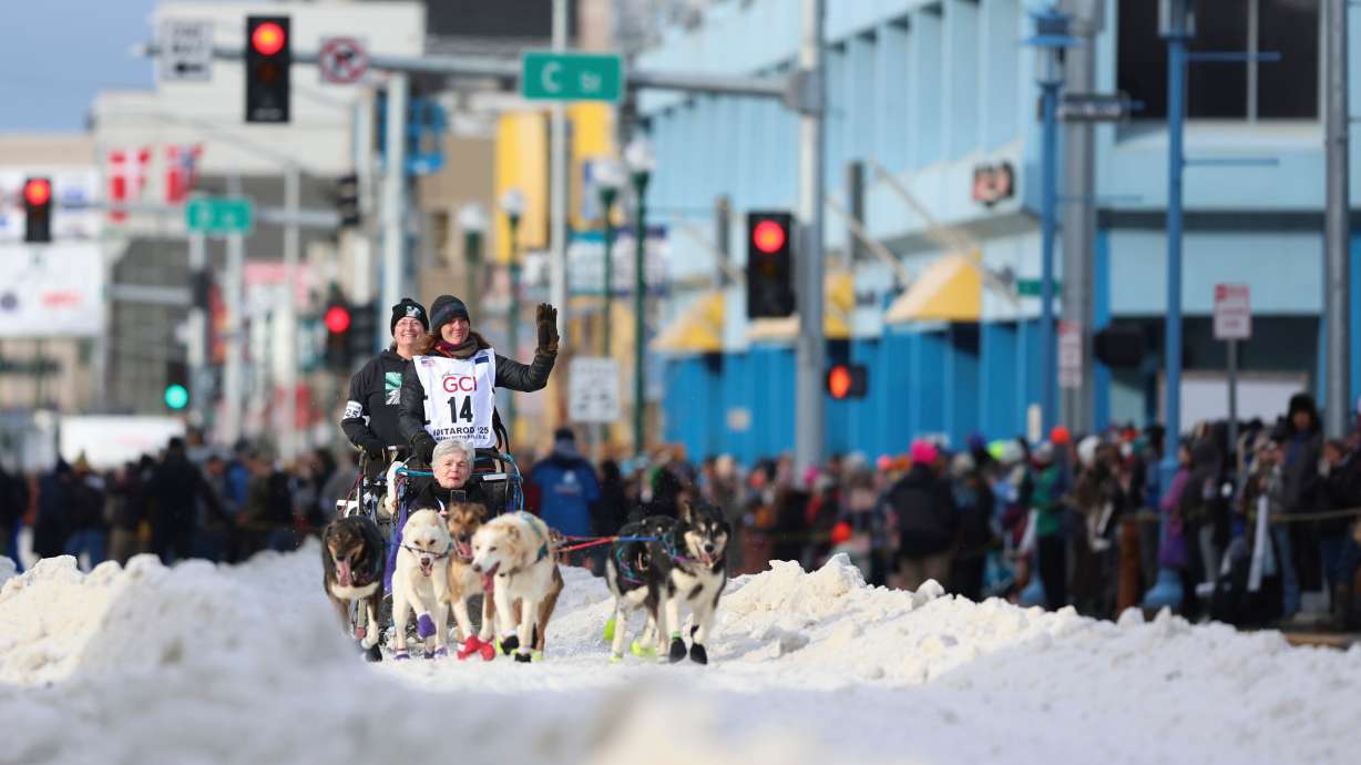 FILE - Michelle Phillips (14), of Canada, mushes down Fourth Street during the Ceremonial Start of the Iditarod Trail Sled Dog Race, in Anchorage, Alaska, March 1, 2025.