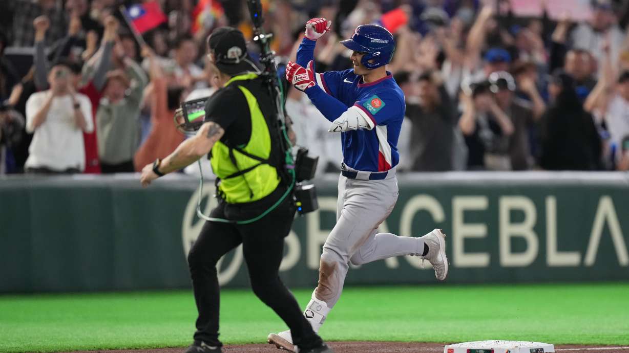 Taiwan's Stuart Fairchild runs past the third base as he calebrates his grand slam home run in the second inning of a World Baseball Classic game between Taiwan and Czechia in Tokyo, Saturday, March 7, 2026.