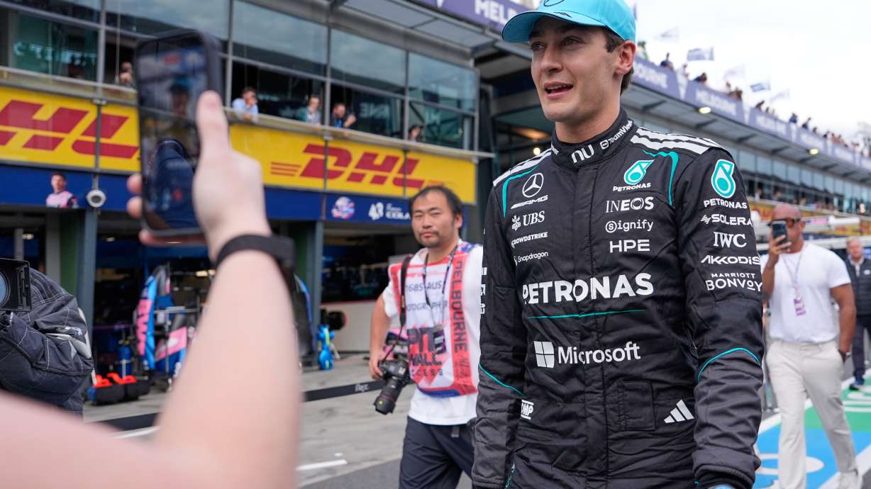 Mercedes driver George Russell of Britain walks down pit lane after winning the qualifying session for the Australian Formula One Grand Prix at Albert Park, in Melbourne, Australia, Saturday, March 7, 2026.