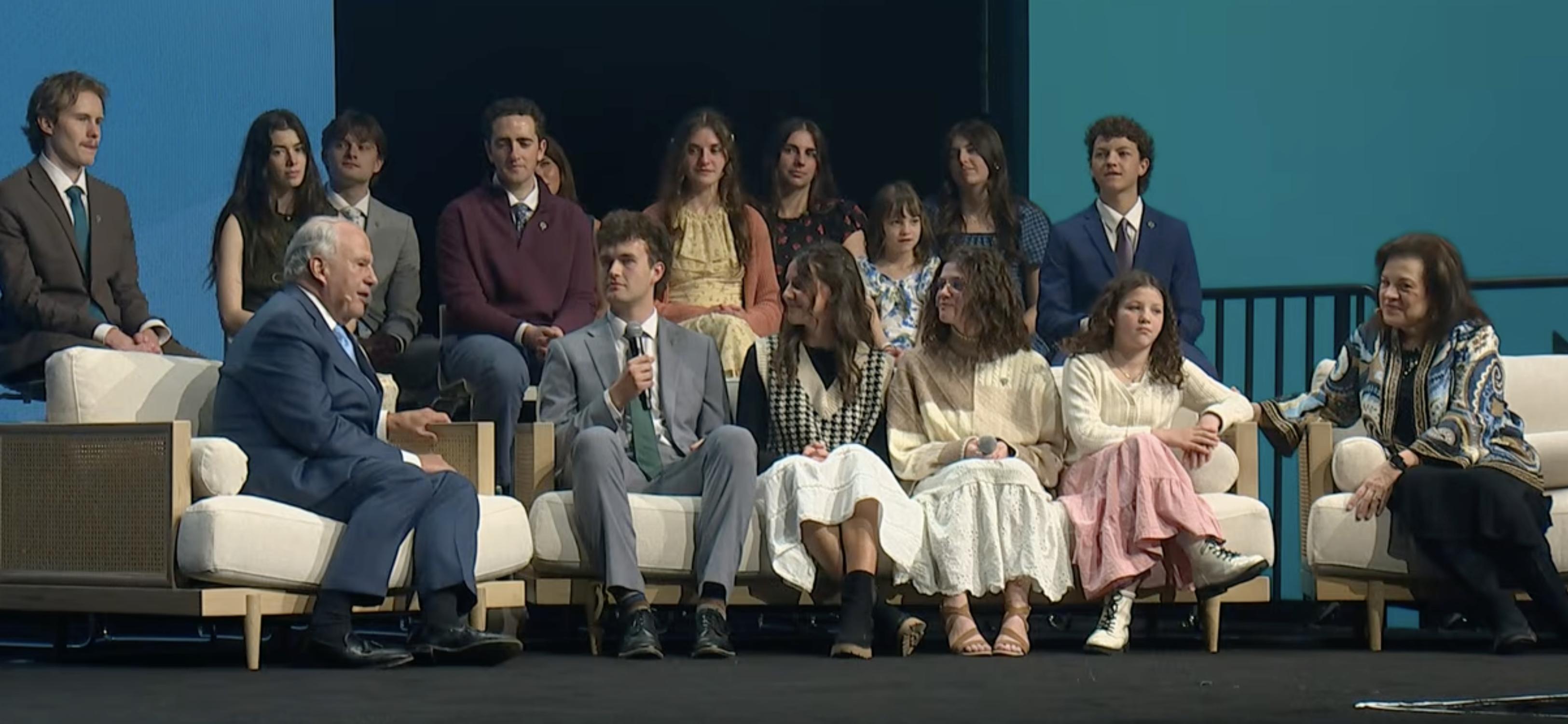 Elder Ronald A. Rasband and his wife, Sister Melanie Rasband, speak with their grandchildren during Family Discovery Day at RootsTech in Salt Lake City on Saturday.