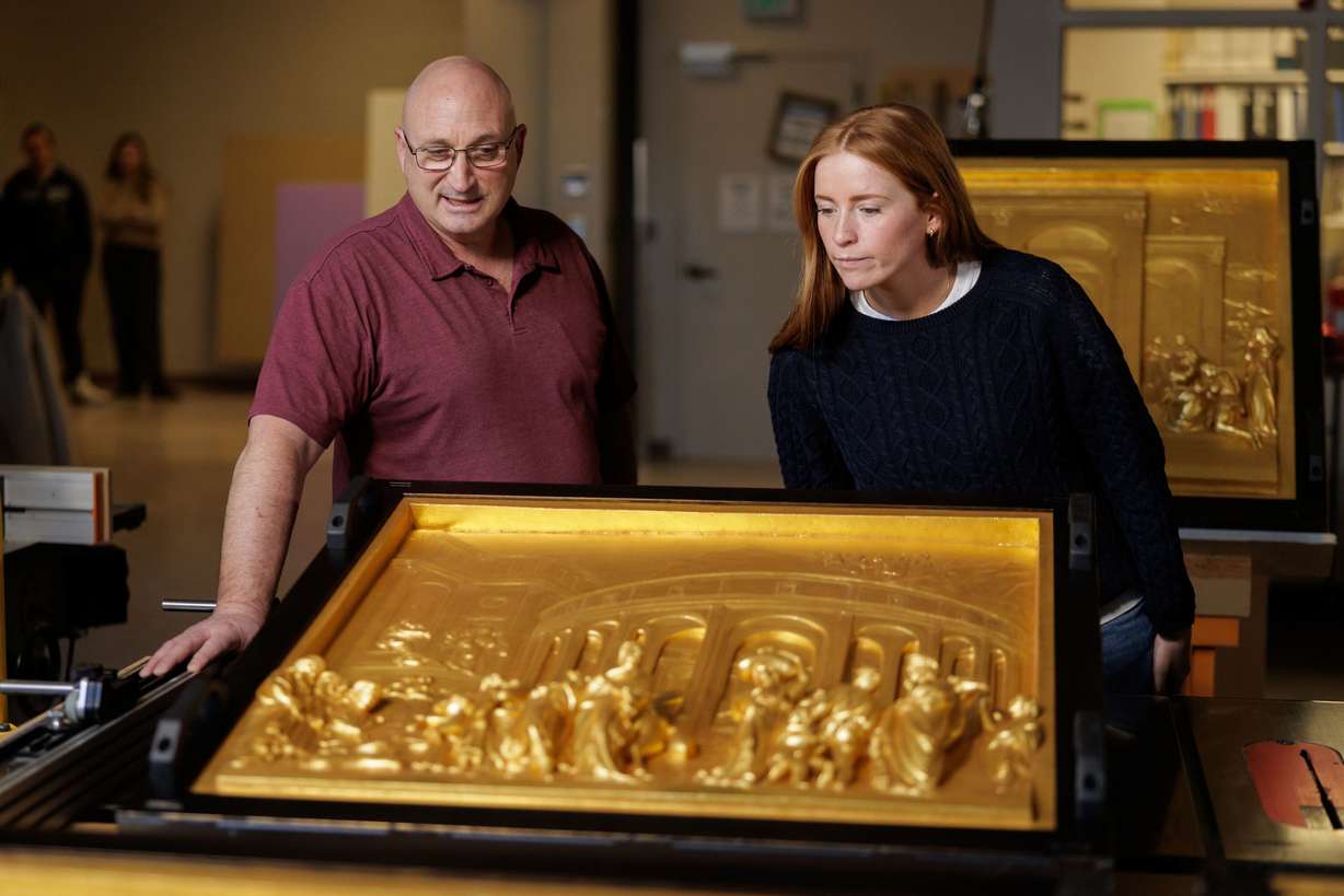 A professor and student looks over restored and gilded plaster casts of Lorenzo Ghiberti’s original sculpture Gates of Paradise. The BYU Museum of Art recently restored the casts in San Giovanni Baptistery in Florence, Italy.
