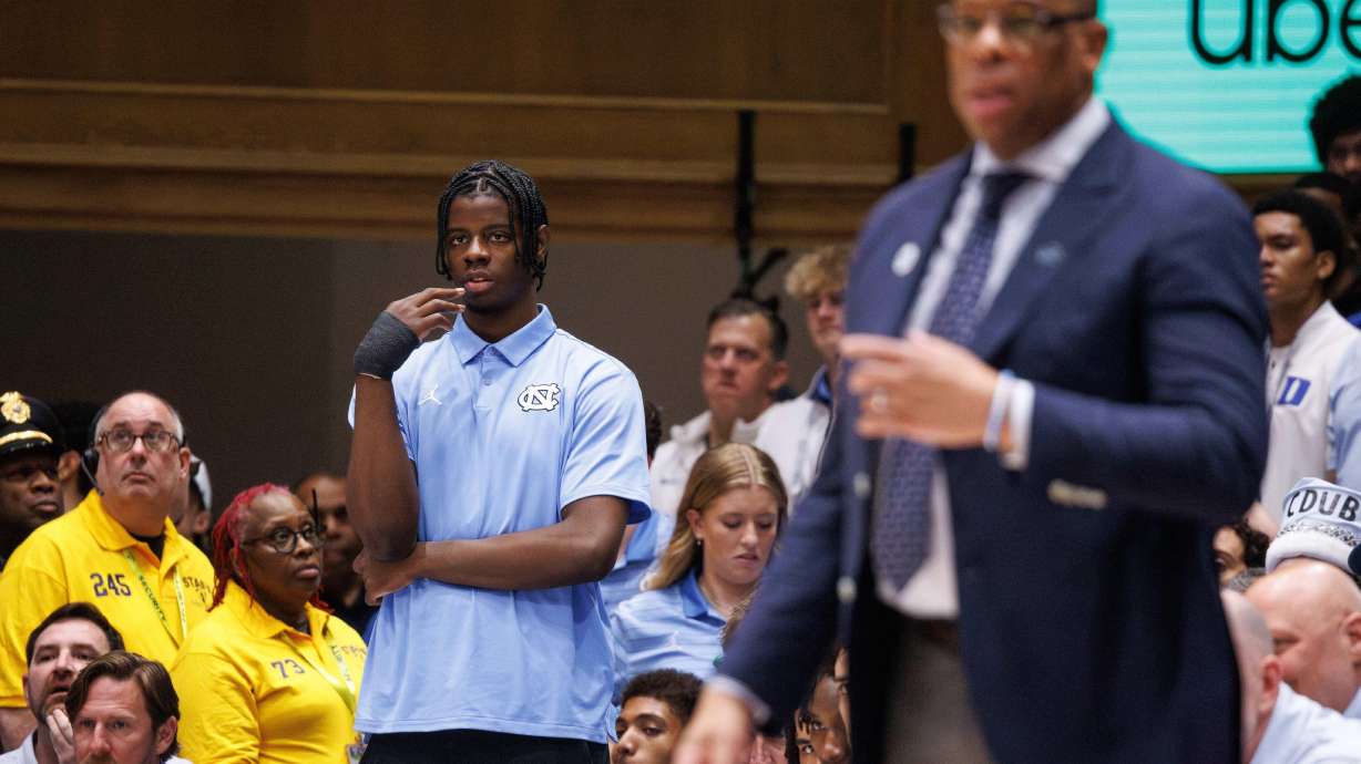 North Carolina's Caleb Wilson,left, who is injured, watches from the bench before an NCAA college basketball game against Duke in Durham, N.C., Saturday, March 7, 2026.