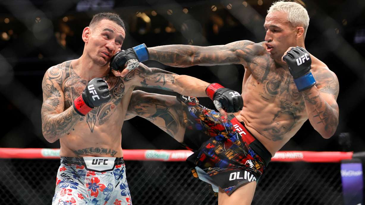 Charles Oliveira, right, punches Max Holloway in a lightweight fight during UFC 326 Saturday, March 7, 2026, in Las Vegas. /Las Vegas Sun via AP)