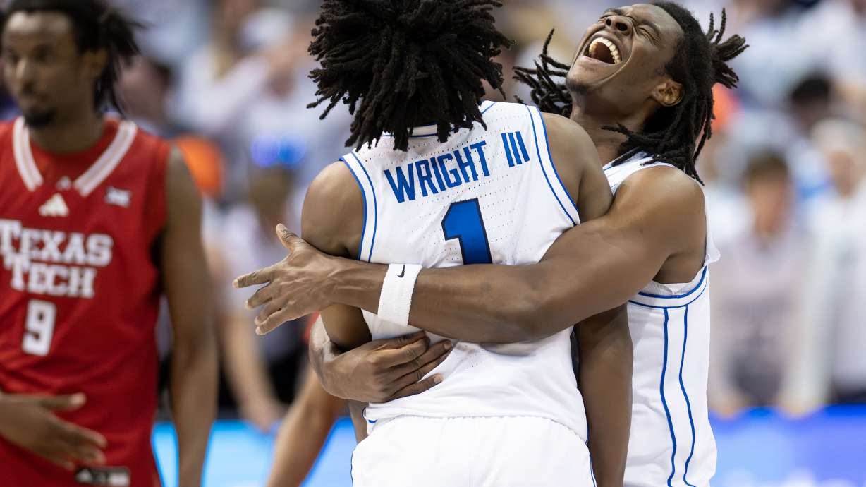 BYU Cougars guard Robert Wright III (1) is hugged by teammate BYU Cougars forward Khadim Mboup (7) as they Cougars defeat the Texas Tech Red Raiders 82-76 nat the Marriott Center in Provo, on Saturday, March 7, 2026.