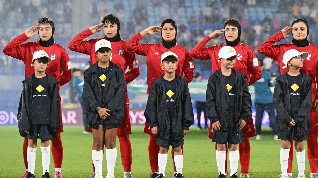 Iran players react during their national anthem ahead of the Women's Asian Cup soccer match between Iran and the Philippines in Robina, Australia, Sunday, March 8, 2026.
