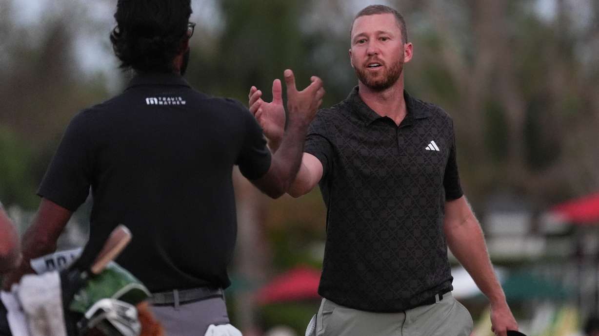 Daniel Berger, right, greets Akshay Bhatia on the 16th hole during the third round of the Arnold Palmer Invitational at Bay Hill golf tournament Saturday, March 7, 2026, in Orlando, Fla.