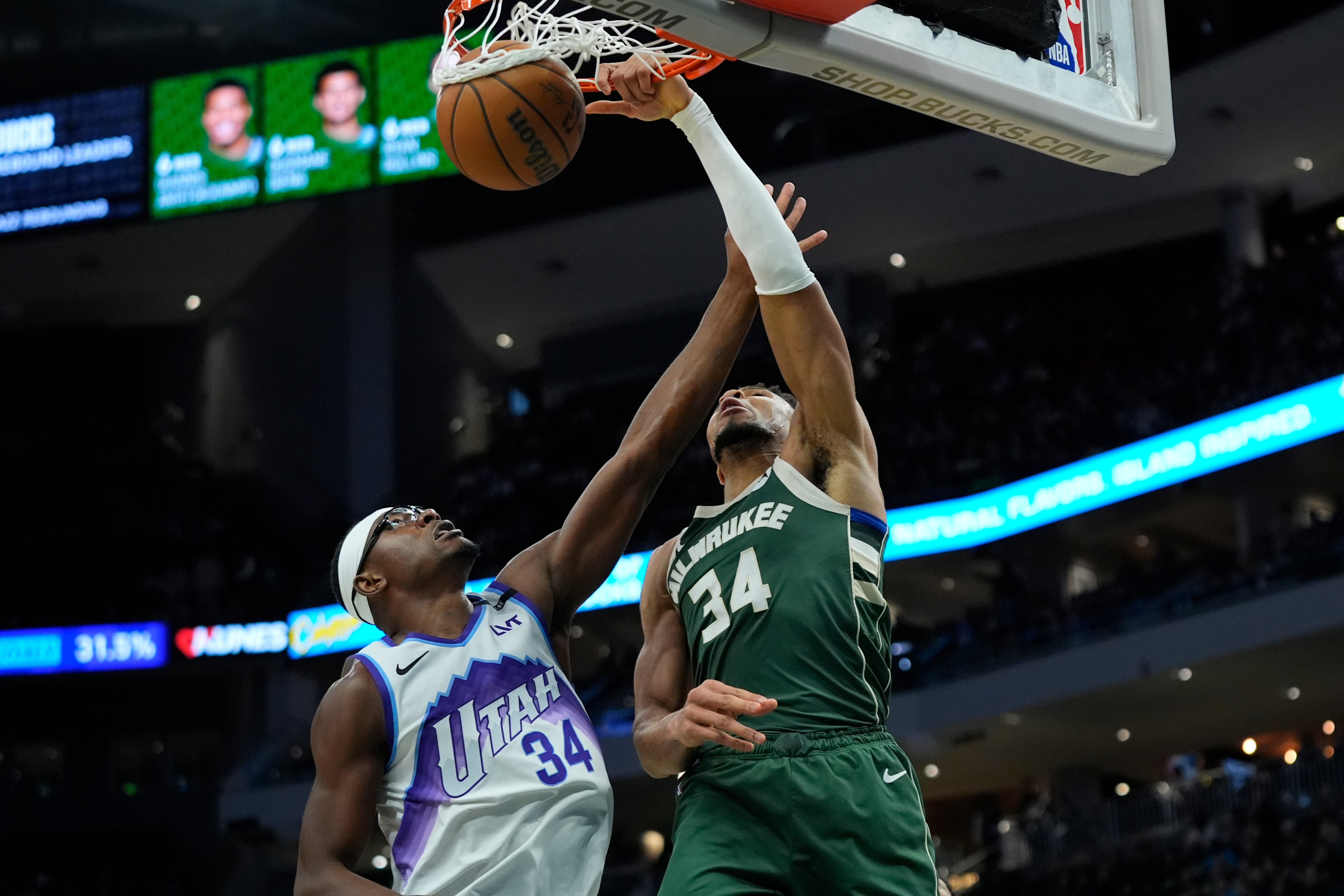 Milwaukee Bucks' Giannis Antetokounmpo, right, dunks over Utah Jazz's Oscar Tshiebwe, left, during the second half of an NBA basketball game Saturday, March 7, 2026, in Milwaukee. 