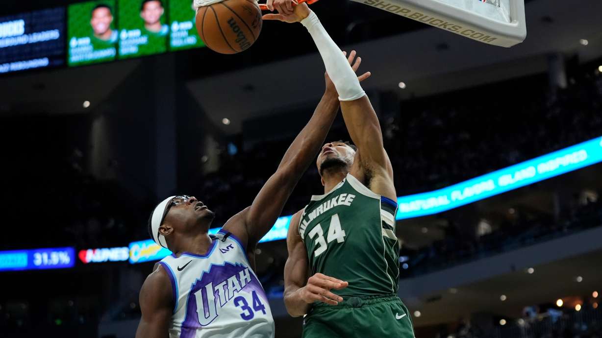 Milwaukee Bucks' Giannis Antetokounmpo, right, dunks over Utah Jazz's Oscar Tshiebwe, left, during the second half of an NBA basketball game Saturday, March 7, 2026, in Milwaukee.