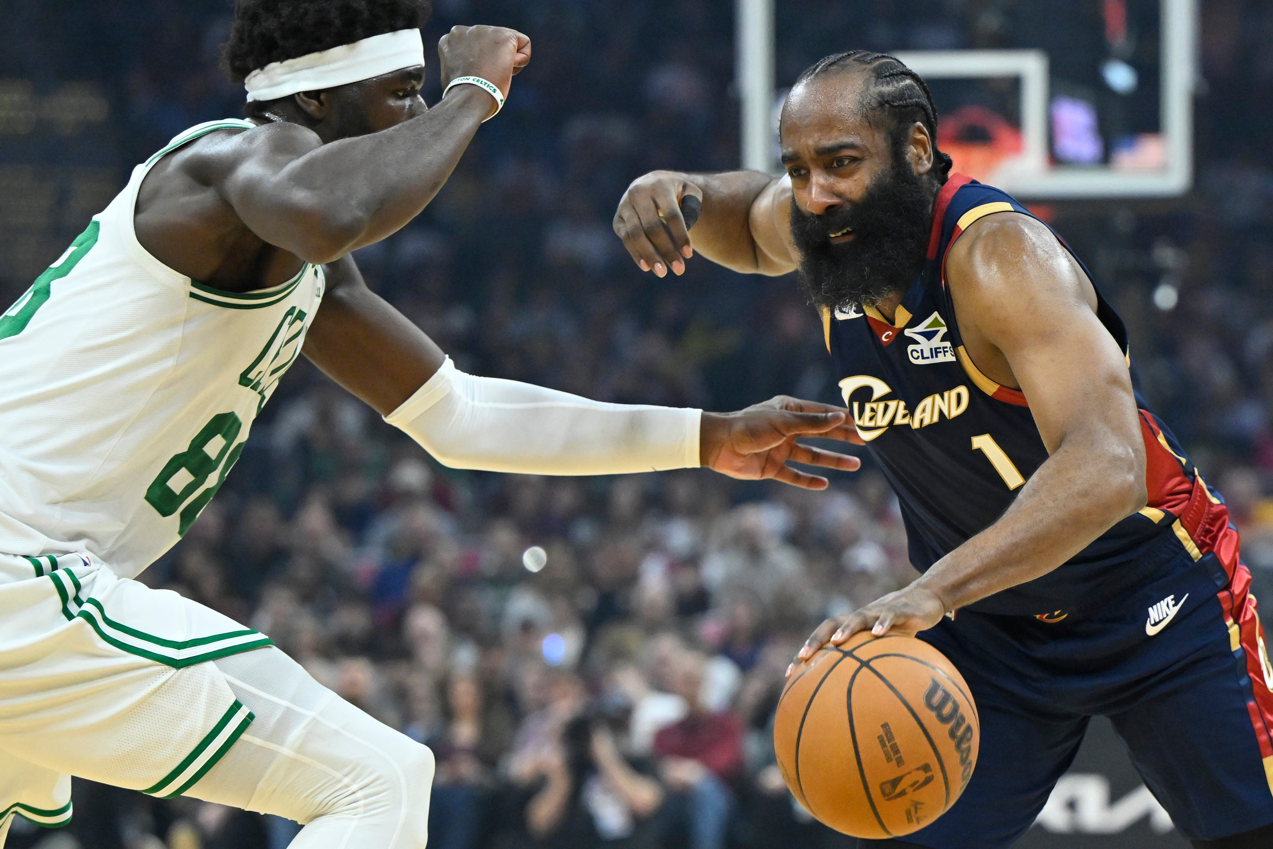 Cleveland Cavaliers guard James Harden (1) dribbles beside Boston Celtics center Neemias Queta in the first half of an NBA basketball game in Cleveland, Sunday, March 8, 2026. 