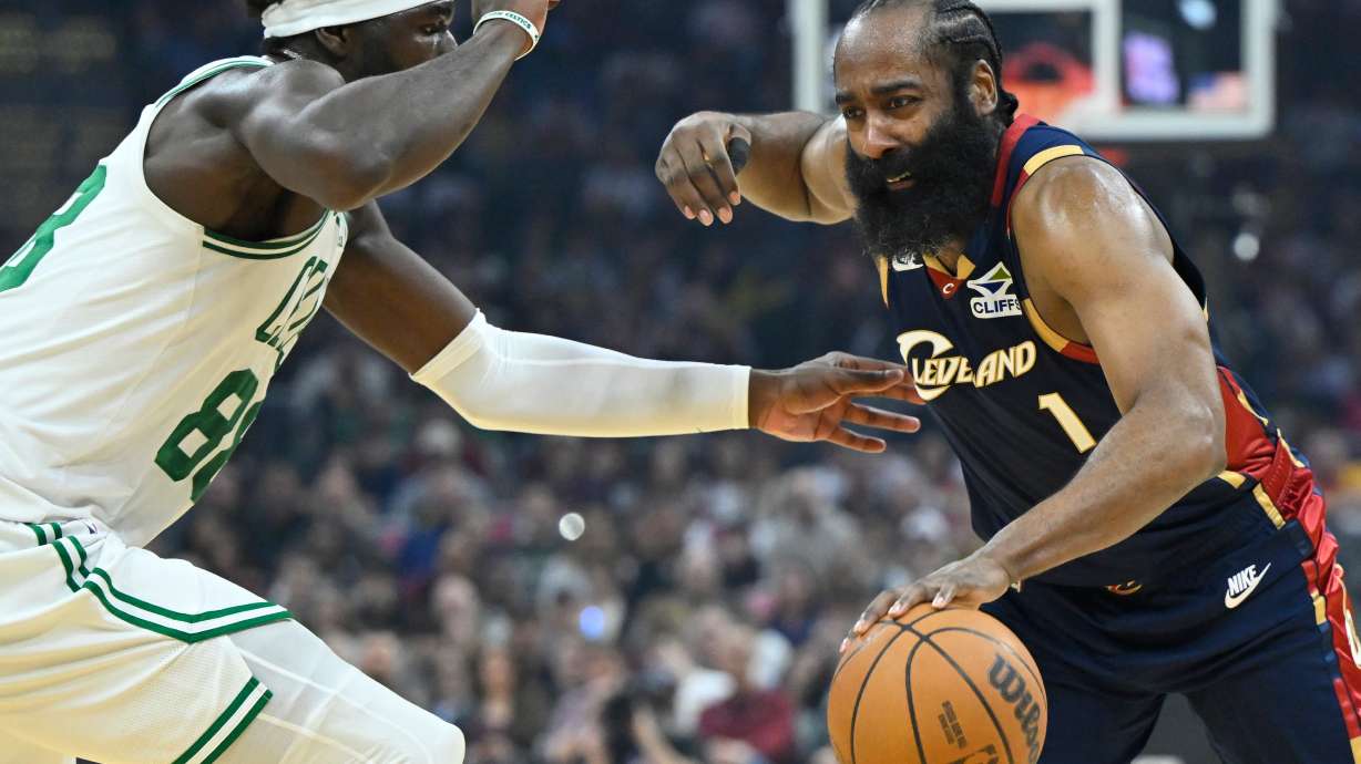 Cleveland Cavaliers guard James Harden (1) dribbles beside Boston Celtics center Neemias Queta in the first half of an NBA basketball game in Cleveland, Sunday, March 8, 2026.