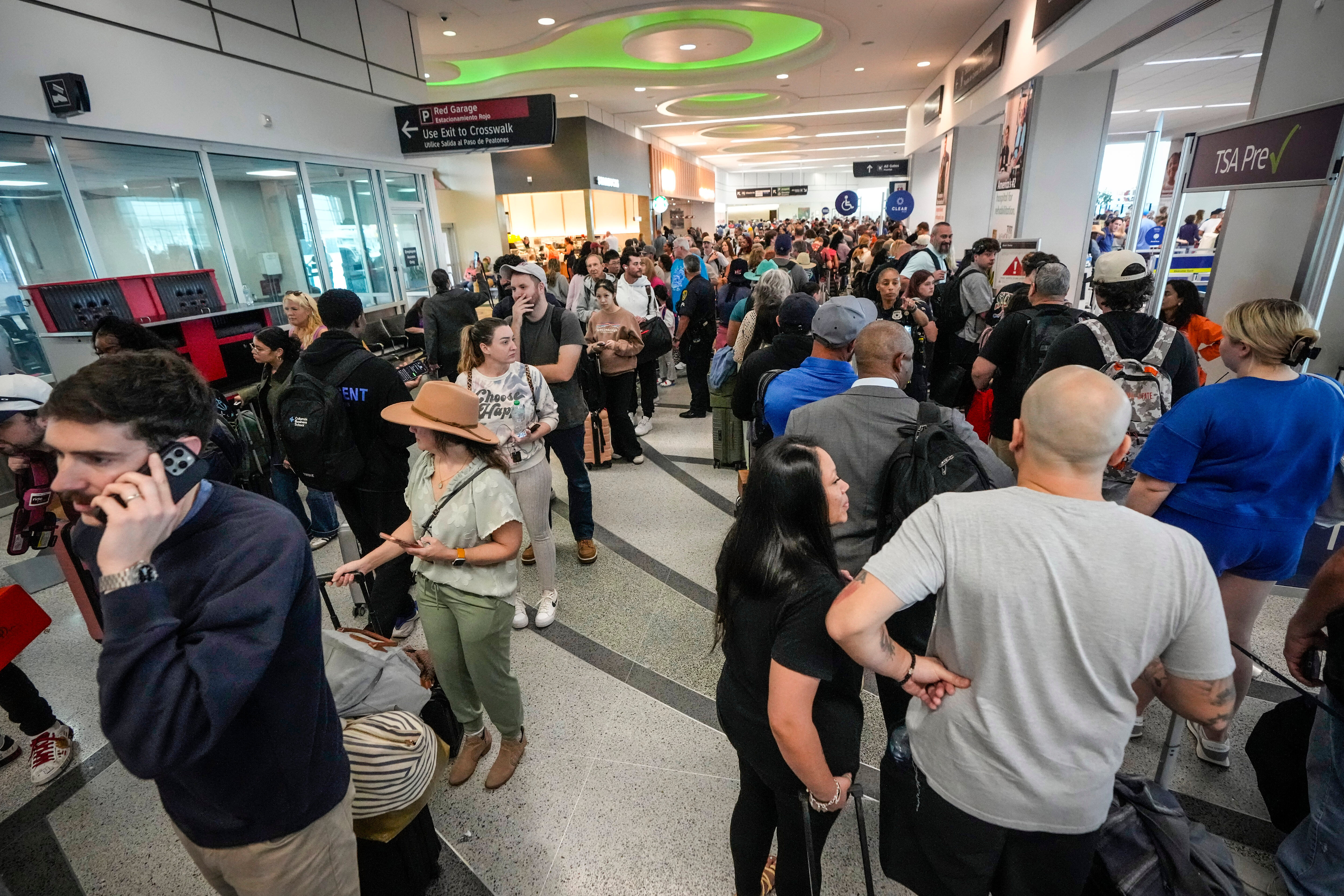 Airline passengers wait in long lines to get through the TSA security screening at William P. Hobby Airport in Houston, Sunday. Travelers complained of long waits Sunday at security checkpoints at airports in Houston and New Orleans, which officials blamed on a government shutdown of the U.S. Department of Homeland Security.