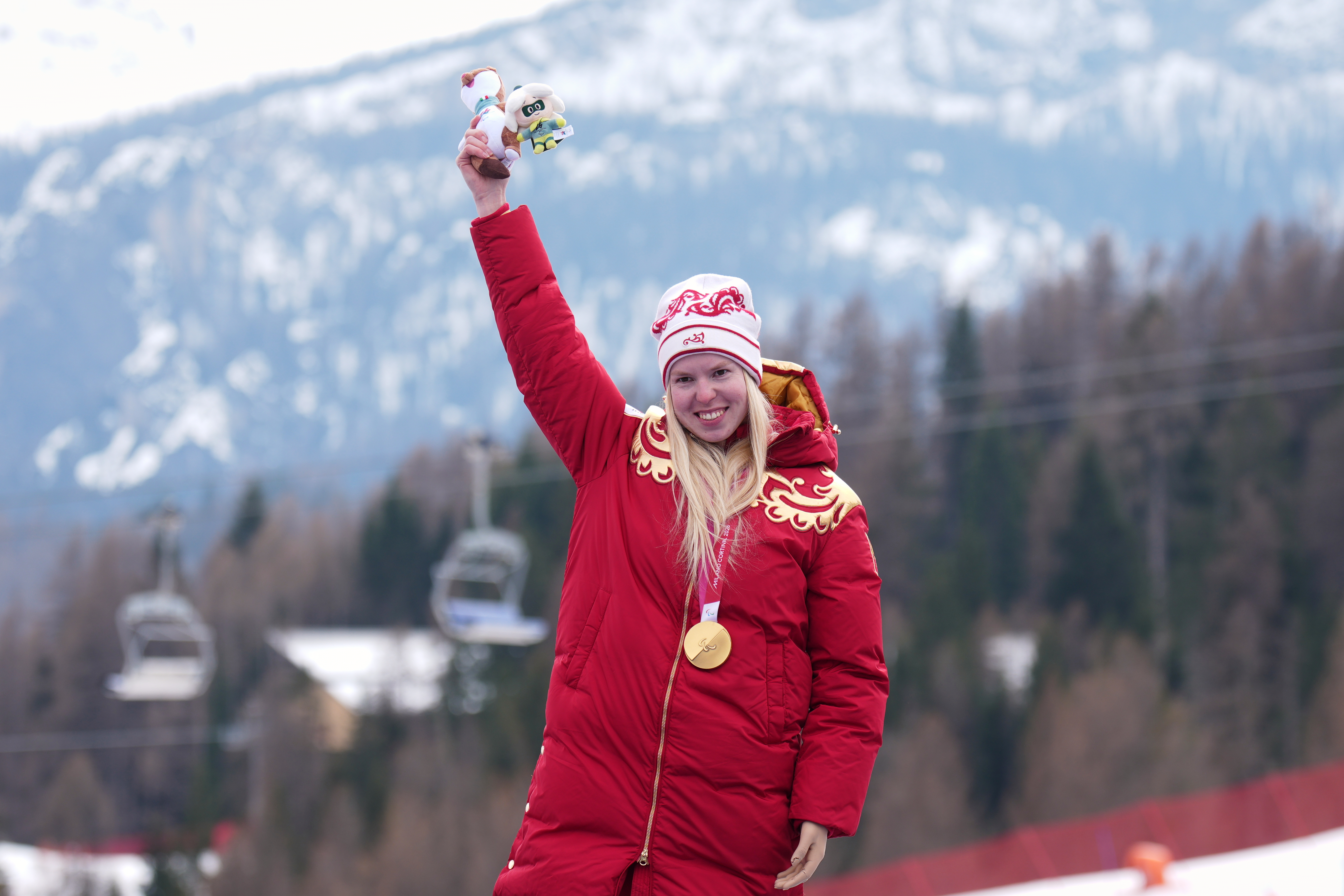 Varvara Voronchikhina, of Russia, smiles on the podium after winning the gold medal in the alpine skiing women's super-G standing at the 2026 Winter Paralympics, in Cortina d'Ampezzo, Italy, Monday, March 9, 2026. 