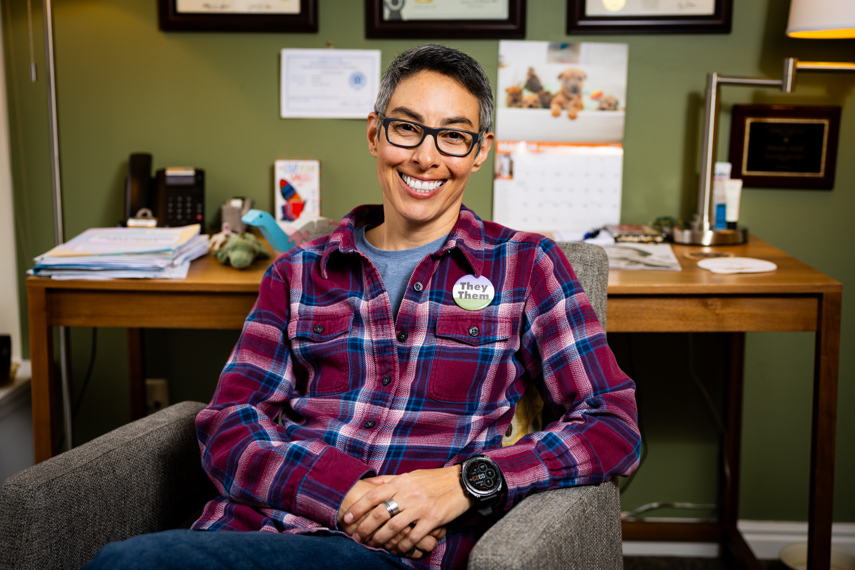 Collin Kuhn, a clinical child and adolescent psychologist who specializes in gender-related care, poses in Salt Lake City on March 3.