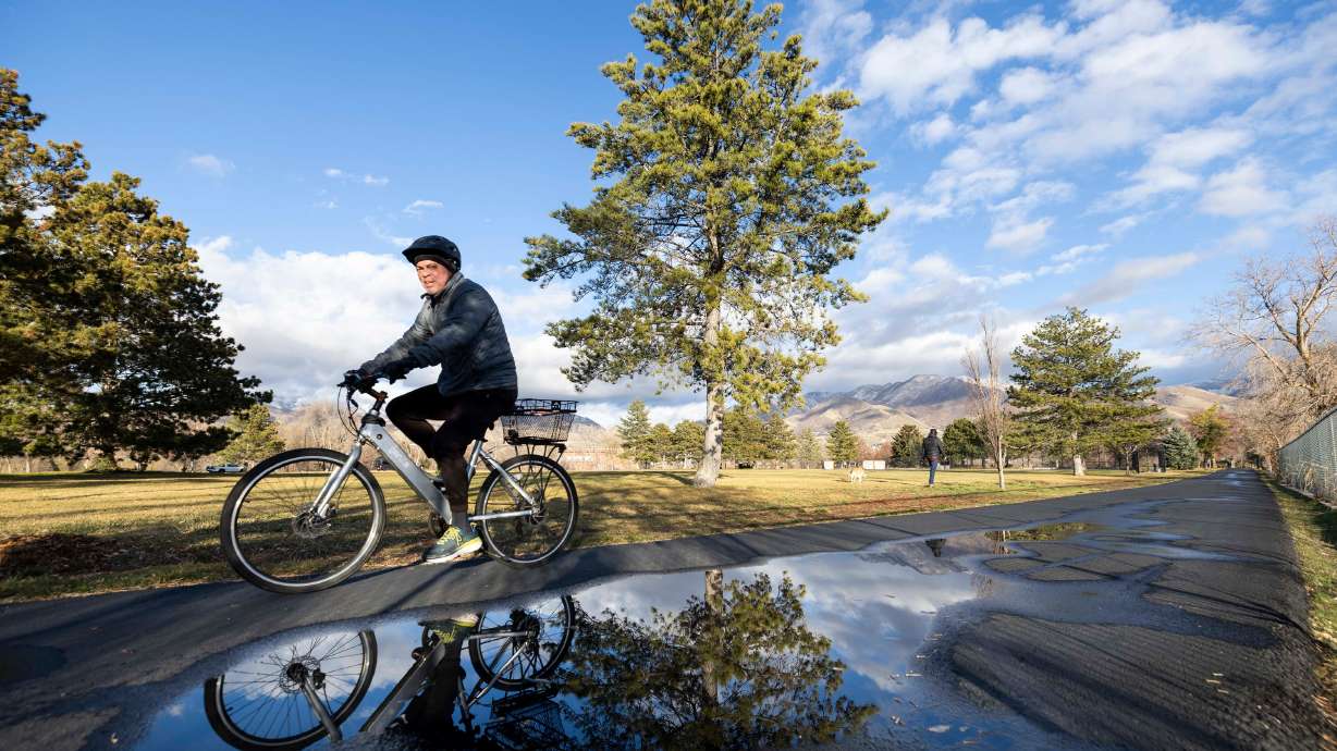 A cyclist rides through Sugar House Park after morning rain in Salt Lake City on Jan. 5. This past meteorological winter was the warmest in Utah history, according to new federal climate data released on Monday.