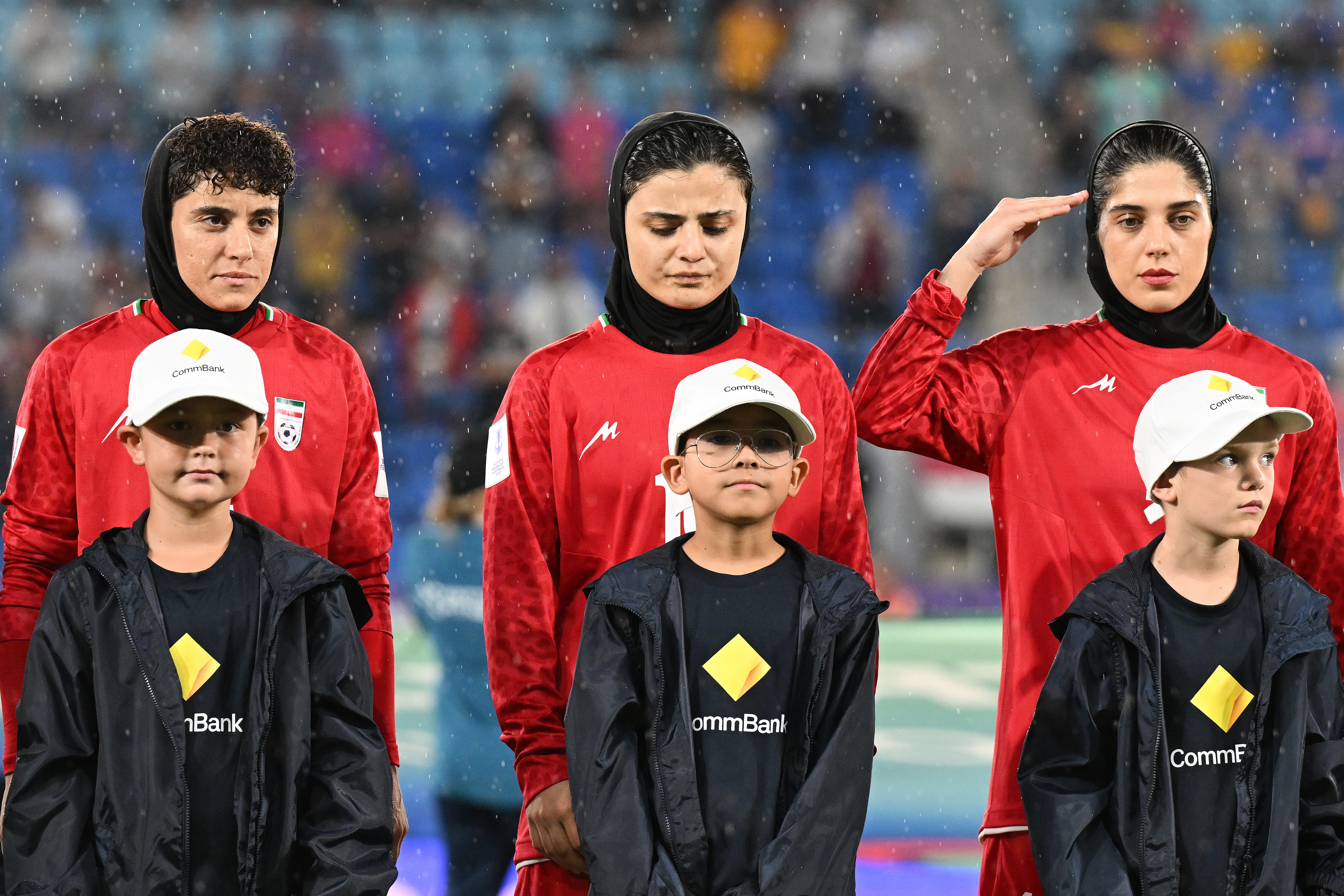 Iran players react during their national anthem ahead of the Women's Asian Cup soccer match between Iran and the Philippines in Robina, Australia, Sunday, March 8, 2026.