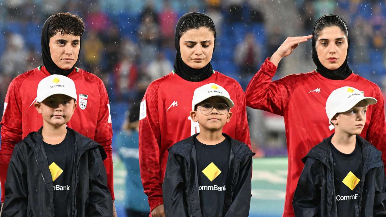 Iran players react during their national anthem ahead of the Women's Asian Cup soccer match between Iran and the Philippines in Robina, Australia, Sunday, March 8, 2026.
