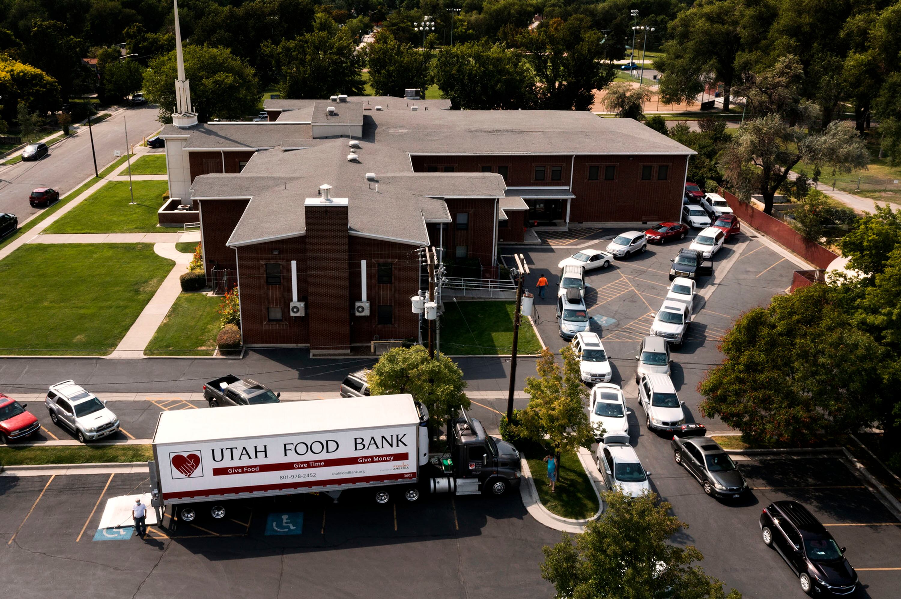 People wait in line to get food at the Utah Food Bank mobile pantry at The Church of Jesus Christ of Latter-day Saints' Cannon Stake Center in Salt Lake City on Sept. 1, 2021.