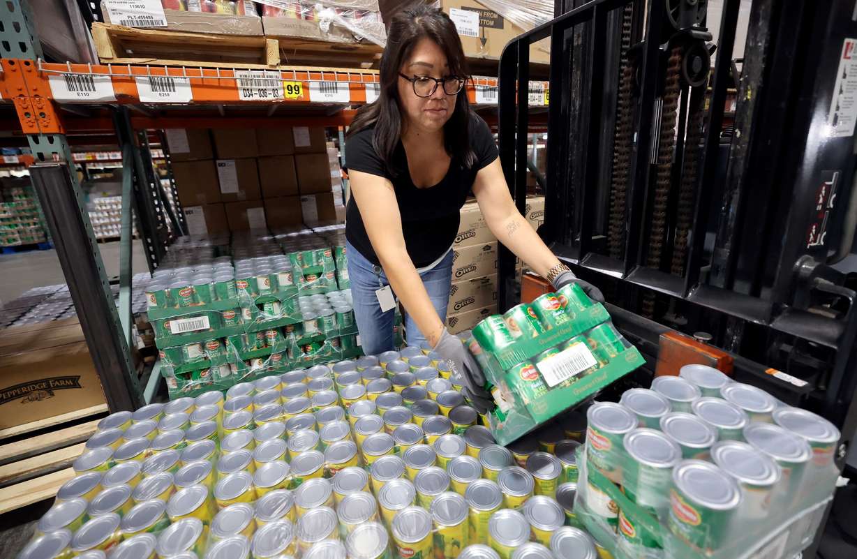 Kristin Chavez, Utah Food Bank warehouse associate, loads canned food onto a forklift at the Utah Food Bank in South Salt Lake on Oct. 27, 2025.