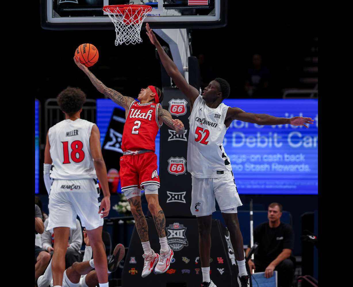 Utah guard Terrence Brown (2) drives to the basket past Cincinnati Bearcats center Moustapha Thiam (52) for a layup during the first half of the game during the 2026 Phillips 66 Big 12 Men's Basketball Tournament at the T-Mobile Center in Kansas City, Mo., on Tuesday, March 10, 2026.
