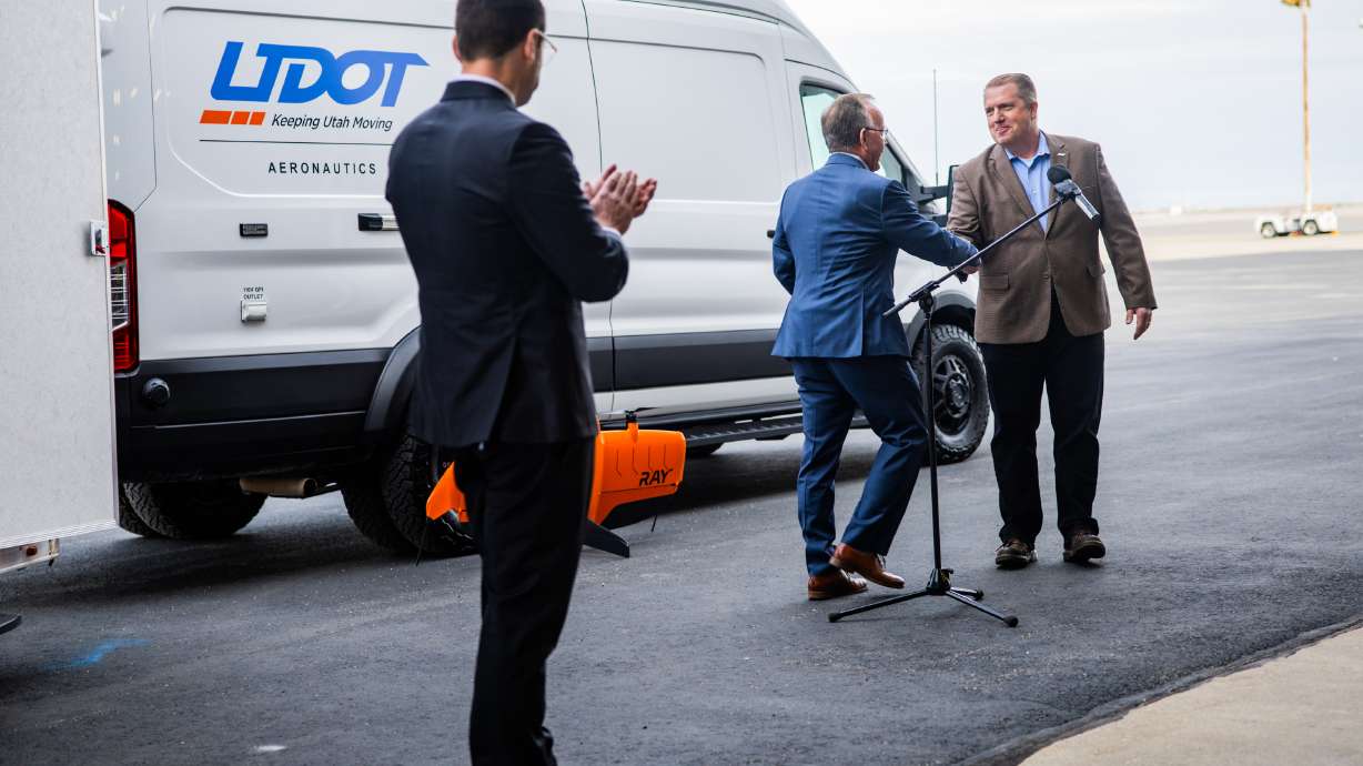 Matt Maass, of Utah Department of Transportation, shakes hands with Senate President Stuart Adams on Tuesday to discuss UDOT’s selection to lead a federal pilot program testing advanced electric aircraft technology in Salt Lake City.