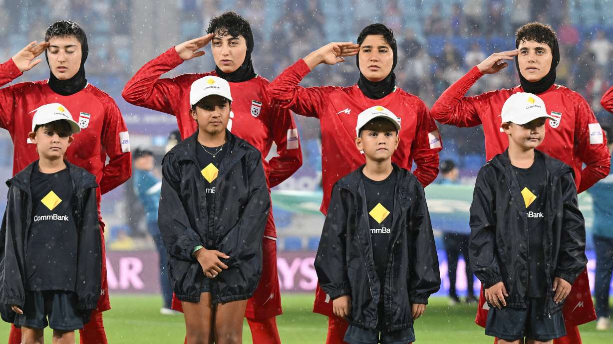 Iran players salute during their national anthem ahead of the Women's Asian Cup soccer match between Iran and the Philippines in Robina, Australia, Sunday, March 8, 2026.