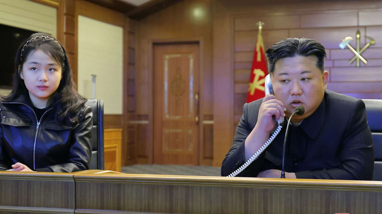 This photo provided by the North Korean government shows its leader Kim Jong Un, right, and his daughter, left, watch what it says are cruise missile launches from the naval destroyer, the Choe Hyon, via video Tuesday in North Korea.