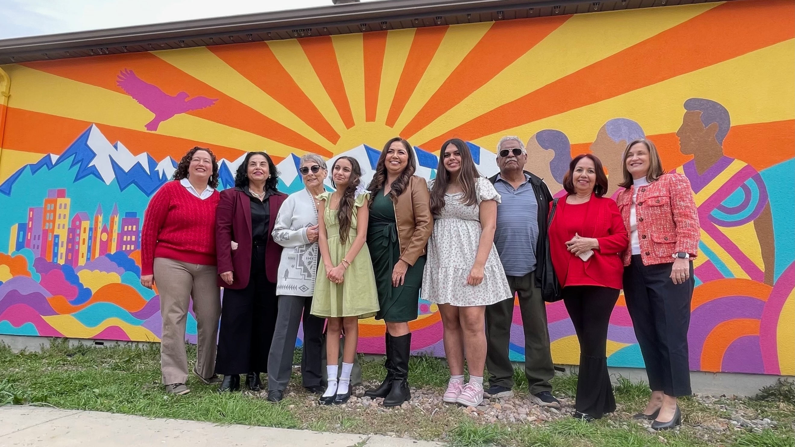 Suazo Business Center reps gathered Tuesday to name the building housing the organization in honor of Gladys Gonzalez, key in its formation, and to unveil a mural on the building exterior. Suazo CEO Silvia Castro Bennett, left, and others are pictured at the event.