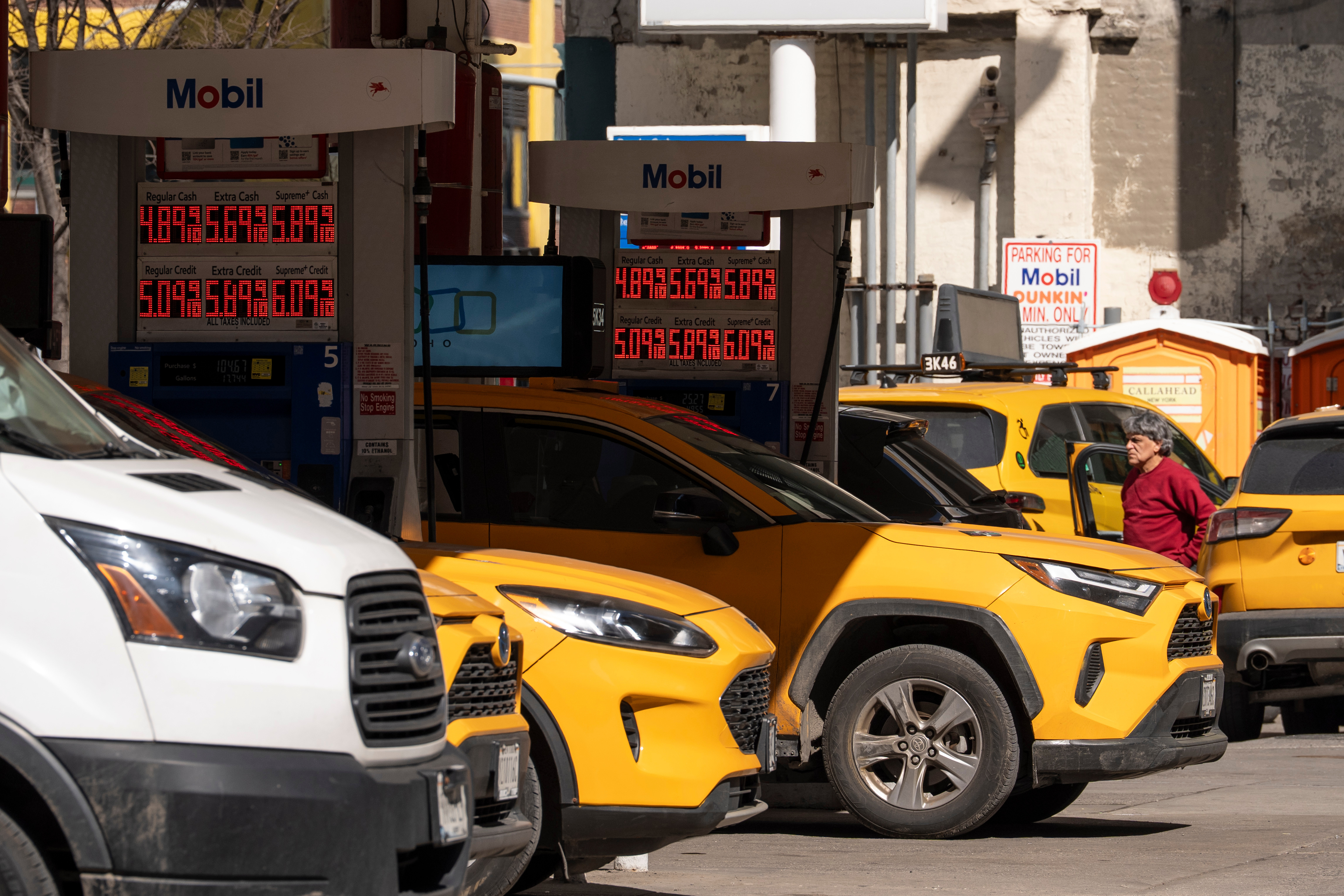 Signs show the gas prices at a gas station, Tuesday, in New York. The International Energy Agency agreed Wednesday to release the largest volume of emergency oil reserves in its history, in a bid to counter the effects on energy markets of the war in the Middle East.