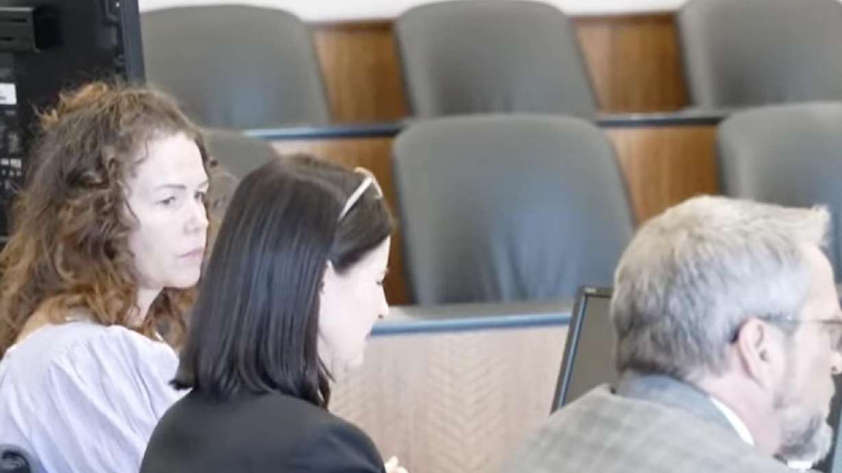 Meggan Sundwall sits with her attorneys on the first day of her jury trial on Wednesday. She is charged with aggravated murder and is accused of killing her friend with an insulin overdose.