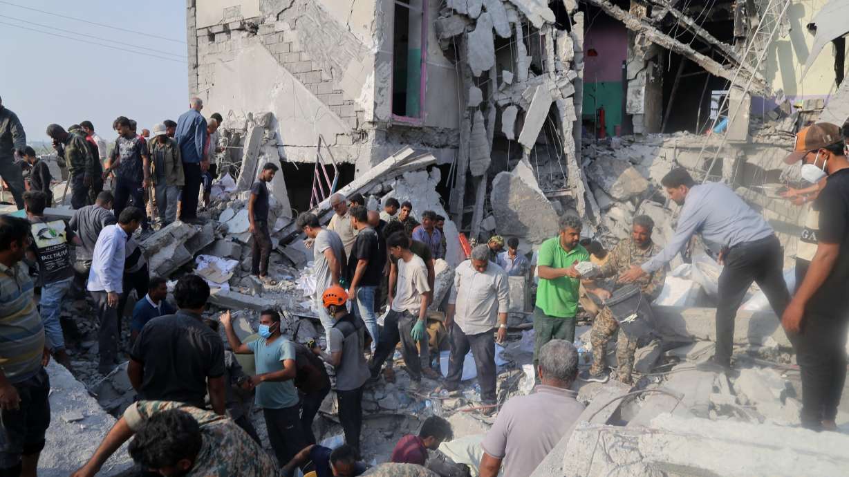 Rescue workers and residents search through the rubble in the aftermath of a strike on an elementary school in Minab, Iran, Feb. 28.