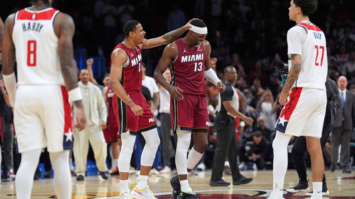 Miami Heat center Bam Adebayo (13) is congratulated by forward Keshad Johnson (16) after reaching 83 points, the second-highest single game total in NBA history, in the second half of an NBA basketball game against the Washington Wizards, Tuesday, March 10, 2026, in Miami.