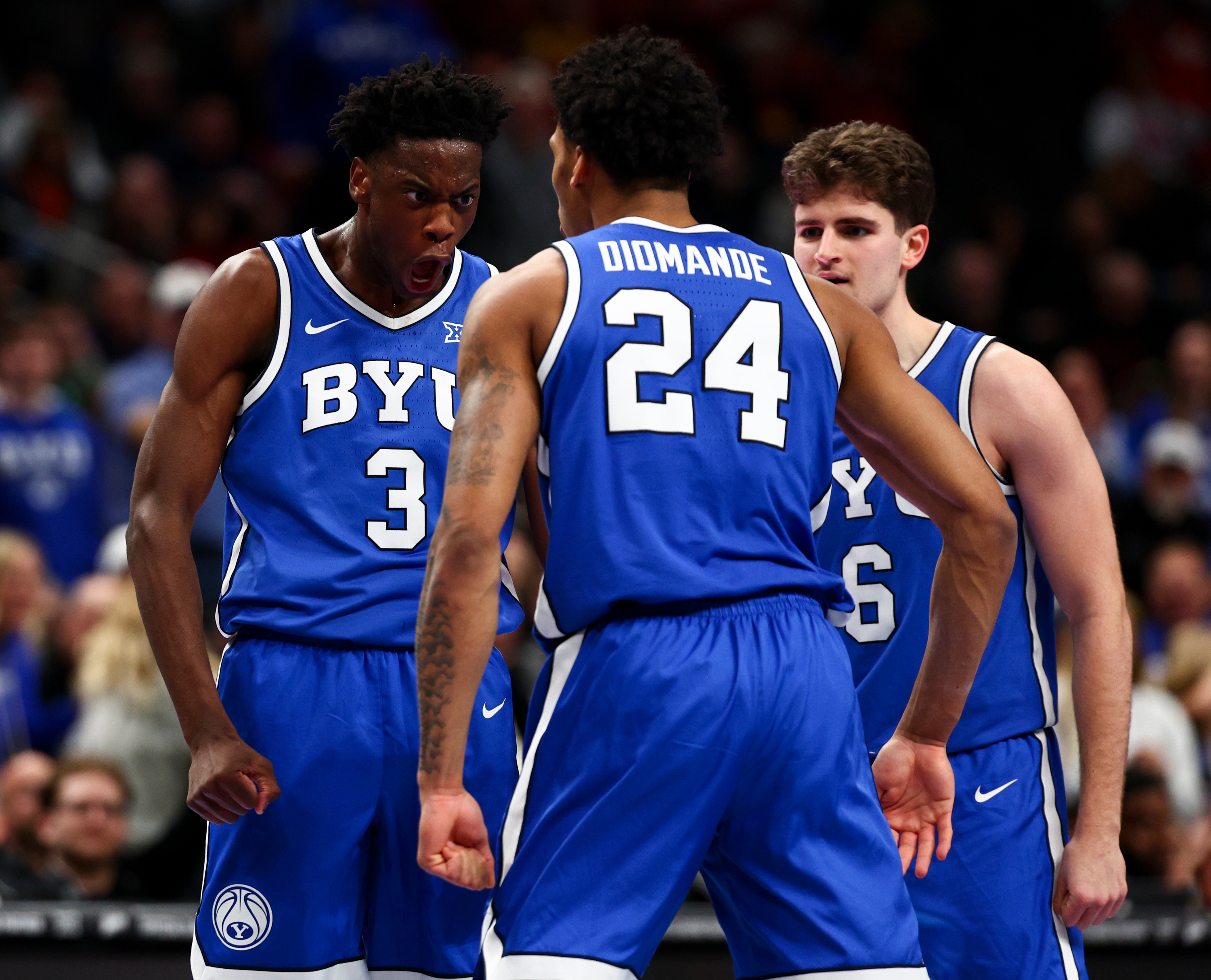 BYU forward AJ Dybantsa (3) celebrates with forward Dominique Diomande (24) and guard Aleksej Kosti? (6) after a dunk by Diomande during the first half of the game against the West Virginia Mountaineers in the second round of the 2026 Phillips 66 Big 12 Men's Basketball Tournament at the T-Mobile Center in Kansas City, Missouri, on Wednesday, March 11, 2026.