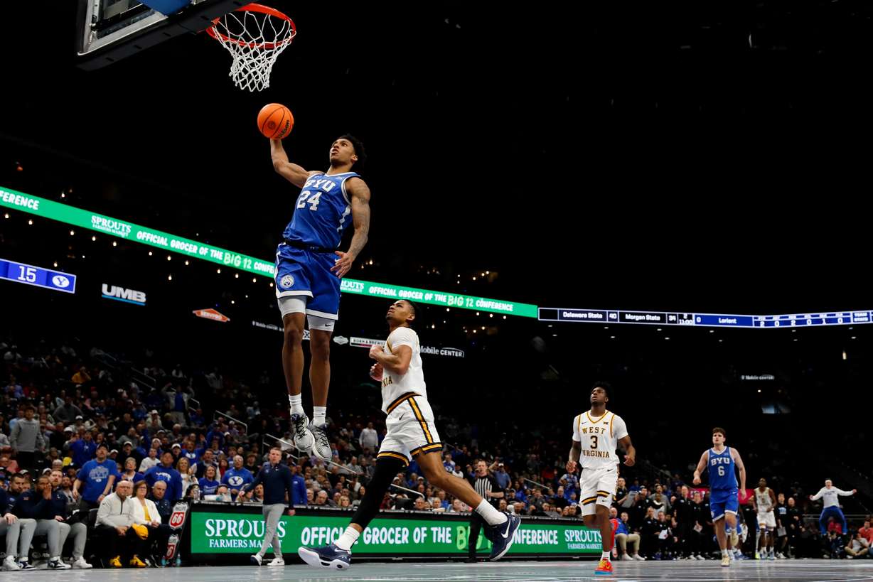 BYU forward Dominique Diomande (24) dunks during the first half of the game against the West Virginia Mountaineers in the second round of the 2026 Phillips 66 Big 12 Men's Basketball Tournament at the T-Mobile Center in Kansas City, Missouri, on Wednesday, March 11, 2026.