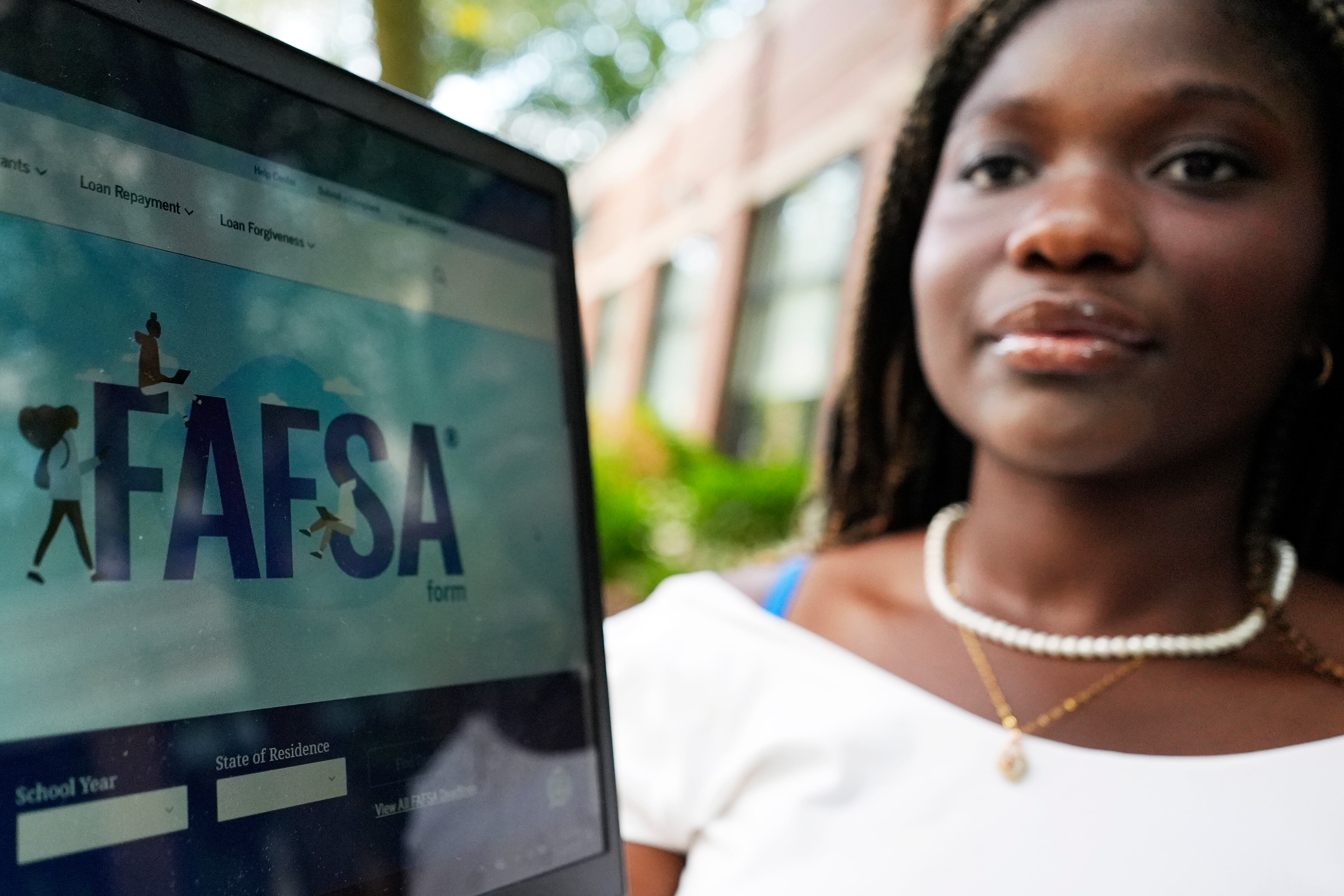 The FAFSA website is seen on a laptop as Adjovi Golo holds the laptop at DePaul University in Chicago, Aug. 28, 2024.