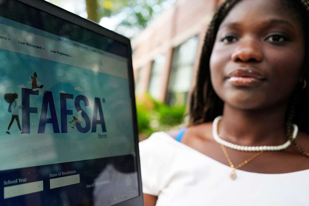 The FAFSA website is seen on a laptop as Adjovi Golo holds the laptop at DePaul University in Chicago, Aug. 28, 2024.