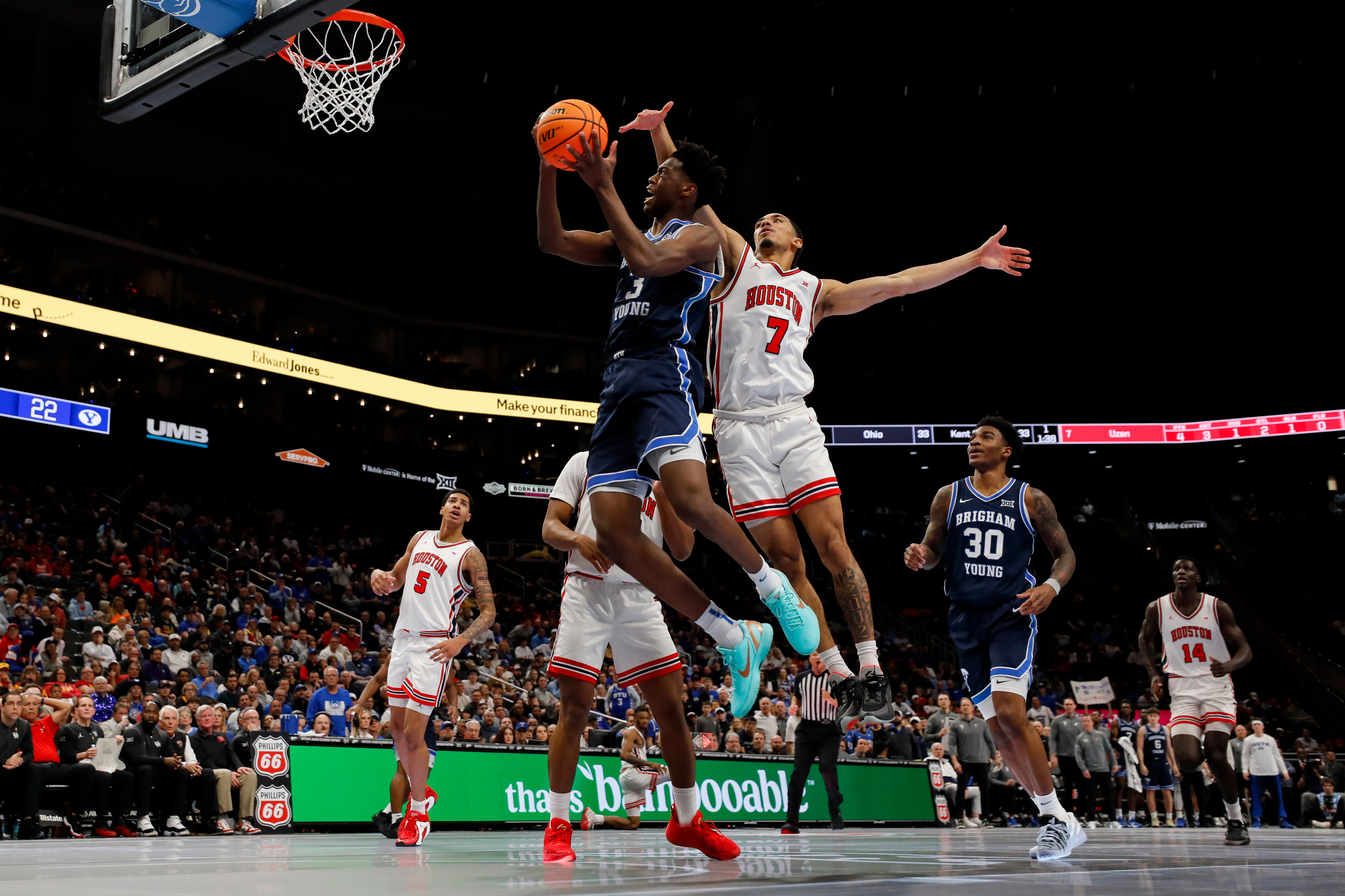 BYU forward AJ Dybantsa (3) drives past Houston Cougars guard Milos Uzan (7) for a lay up during the first half of the quarterfinal of the 2026 Phillips 66 Big 12 Men's Basketball Tournament at the T-Mobile Center in Kansas City, Missouri, on Thursday, March 12, 2026.