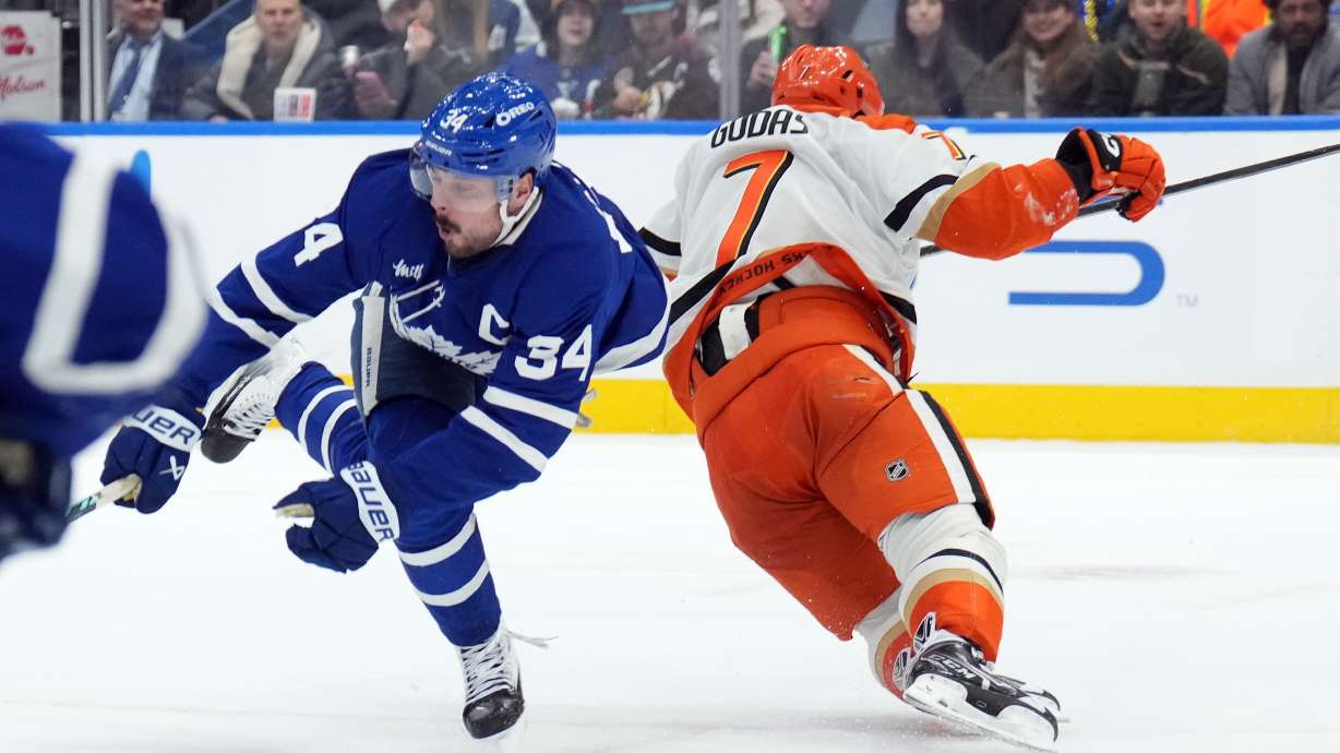 Toronto Maple Leafs Auston Matthews (34) is injured by Anaheim Ducks Radko Gudas (7) during the second period of an NHL hockey game in Toronto, Thursday, March 12, 2026.