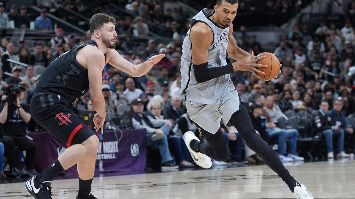 San Antonio Spurs forward Victor Wembanyama (1) drives around Houston Rockets center Alperen Sengun (28) during the first half of an NBA basketball game in San Antonio, Sunday, March 8, 2026.