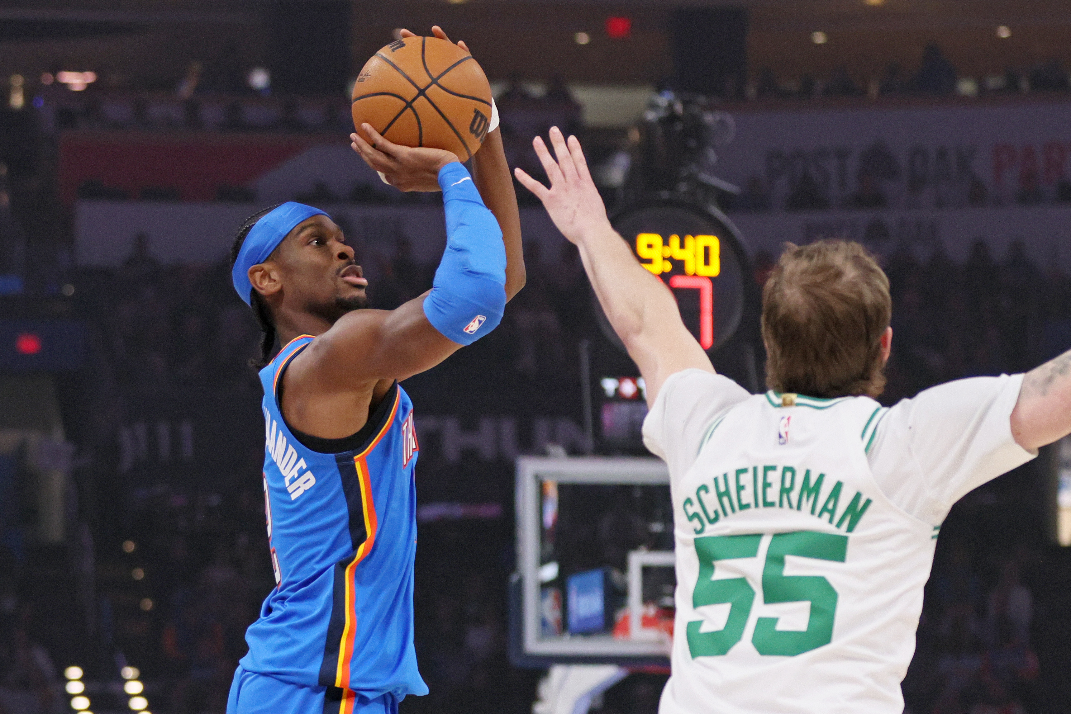 Oklahoma City Thunder guard Shai Gilgeous-Alexander, left, looks to shoot against Boston Celtics guard Baylor Scheierman (55) during the first half of an NBA basketball game, Thursday, March 12, 2026, in Oklahoma City.