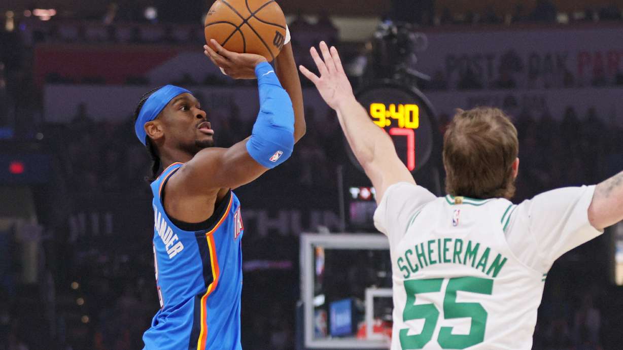 Oklahoma City Thunder guard Shai Gilgeous-Alexander, left, looks to shoot against Boston Celtics guard Baylor Scheierman (55) during the first half of an NBA basketball game, Thursday, March 12, 2026, in Oklahoma City.