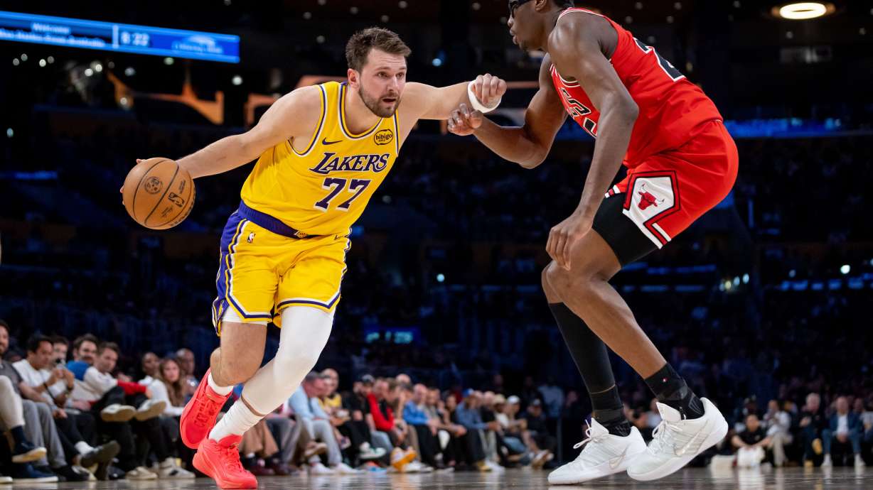Los Angeles Lakers guard Luka Doncic (77) is defended by Chicago Bulls forward Jalen Smith, right, during the first half of an NBA basketball game against the Chicago Bulls, Thursday, March 12, 2026, in Los Angeles.