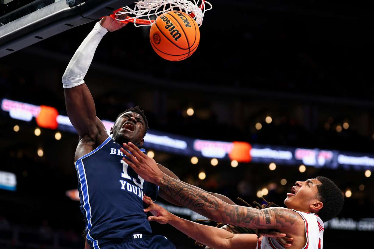 BYU center Keba Keita (13) dunks over Houston Cougars center Chris Cenac Jr. (5) during the second half of the quarterfinal of the 2026 Phillips 66 Big 12 Men's Basketball Tournament at the T-Mobile Center in Kansas City, Missouri, on Thursday, March 12, 2026.