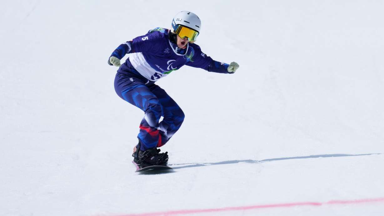 Cecile Hernandez, of France, approaches the finish line in her second run of the snowboard women's banked slalom sb-ll2 at the 2026 Winter Paralympics, in Cortina d'Ampezzo, Italy, Friday, March 13, 2026.
