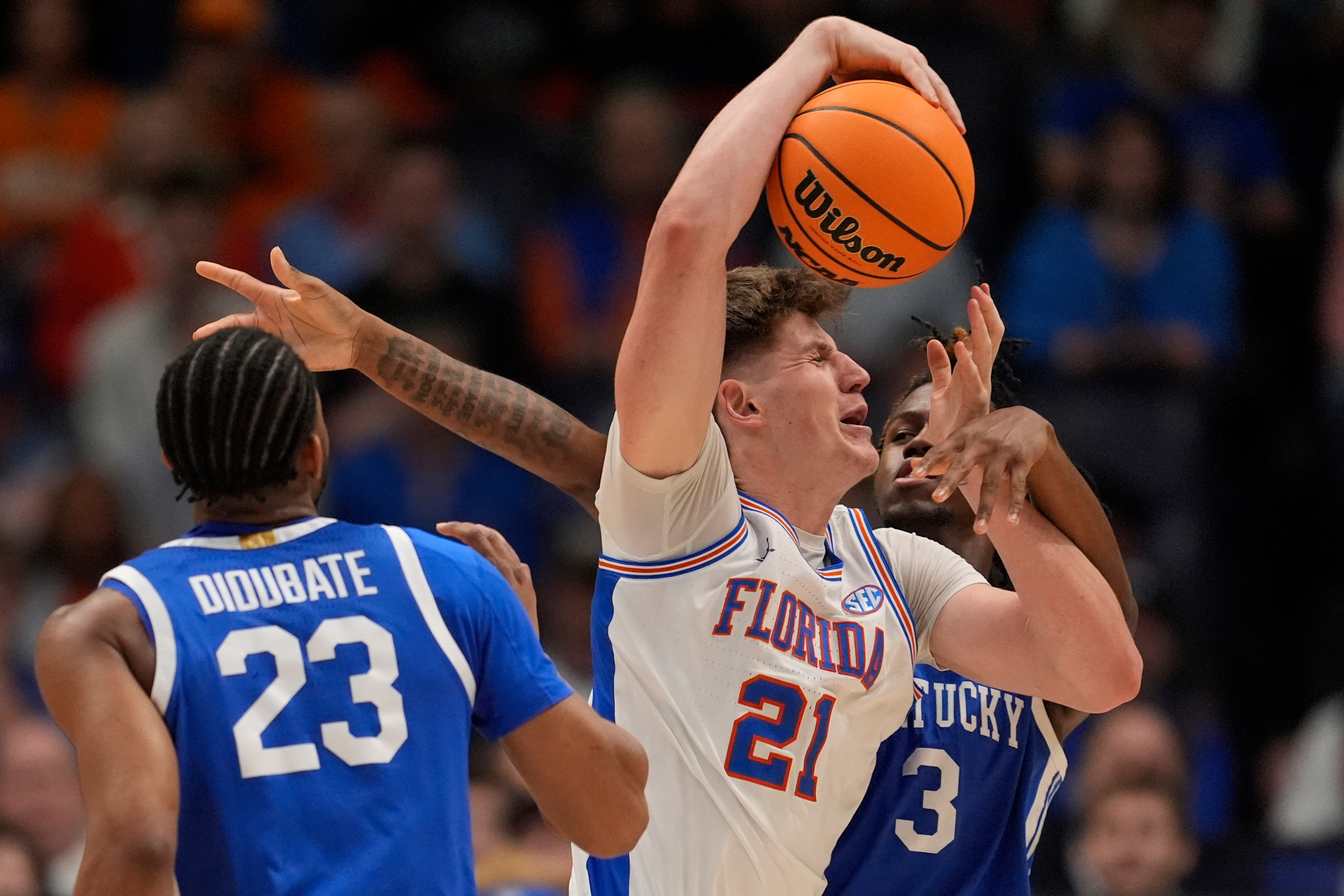 Florida forward Alex Condon (21) drives against Florida center Micah Handlogten (3) during the first half of an NCAA college basketball game in the quarterfinal round of the Southeastern Conference tournament, Friday, March 13, 2026, in Nashville, Tenn.