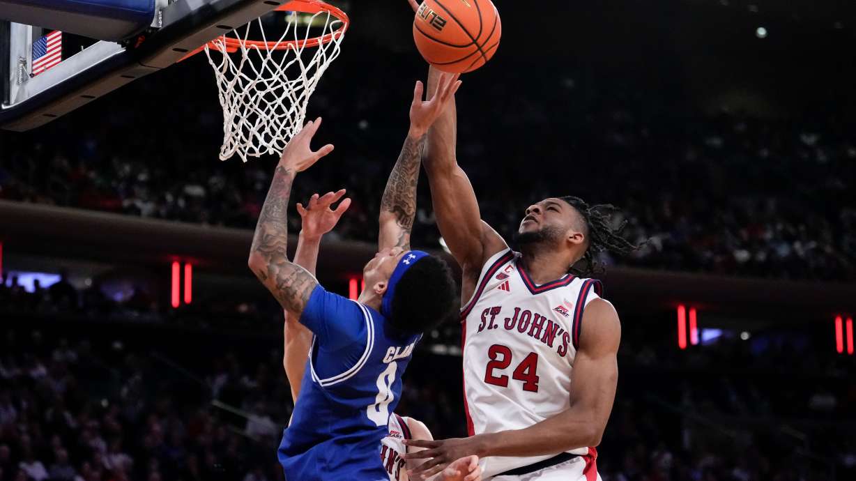 St. John's forward Zuby Ejiofor (24) blocks Seton Hall guard Adam Clark (0) during the second half of an NCAA college basketball game in the semifinals of the Big East tournament, Friday, March 13, 2026, in New York.